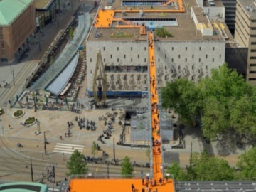 Ένας πορτοκαλί πεζόδρομος γεφυρώνει στέγες κτηρίων στο Ρότερνταμ